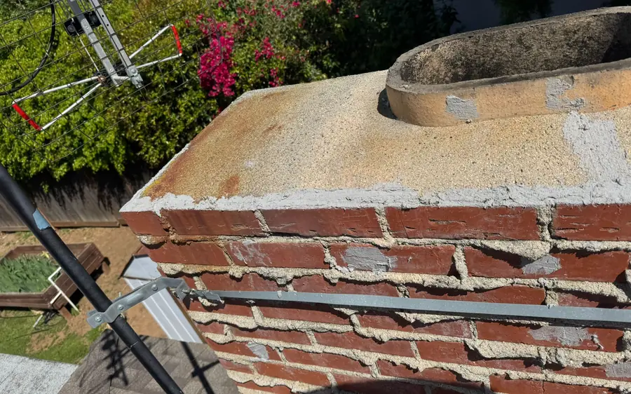 Chimney crown and brick with worn mortar joints