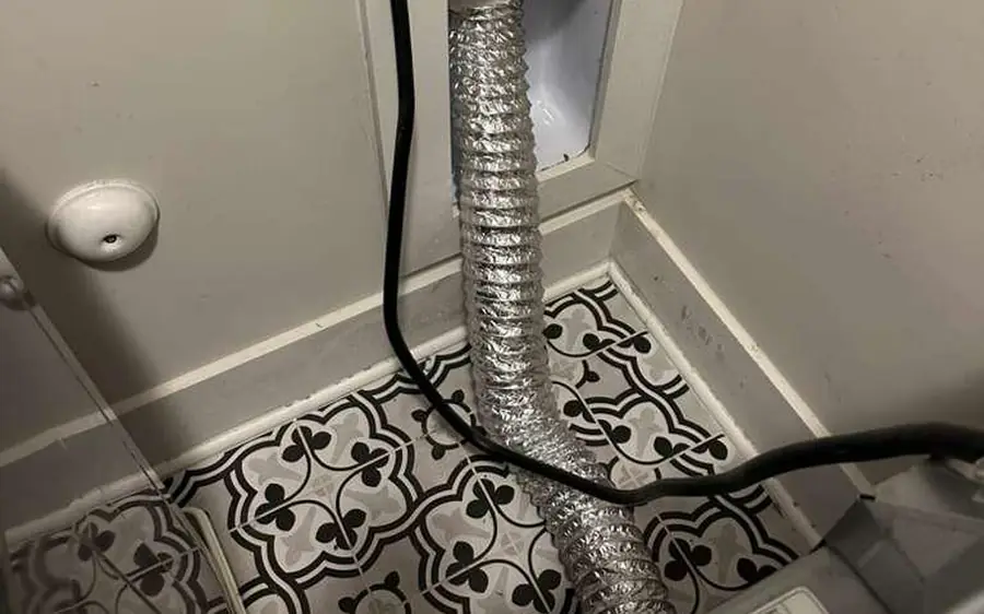 Flexible foil dryer duct behind a dryer in a laundry room